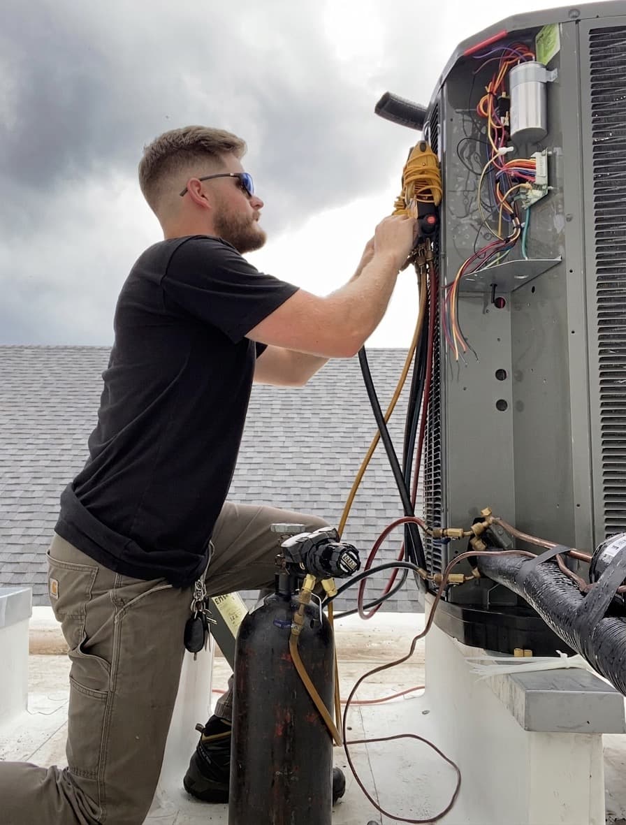 Founder on a roof beside an HVAC unit